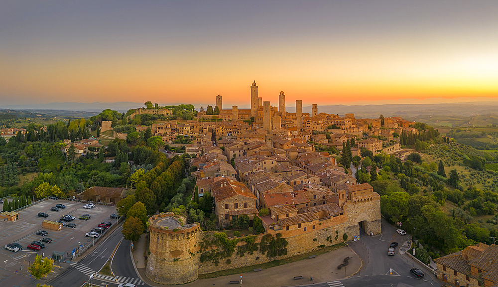 Elevated view of rooftops and town at sunrise, San Gimignano, Tuscany, Italy, Europe