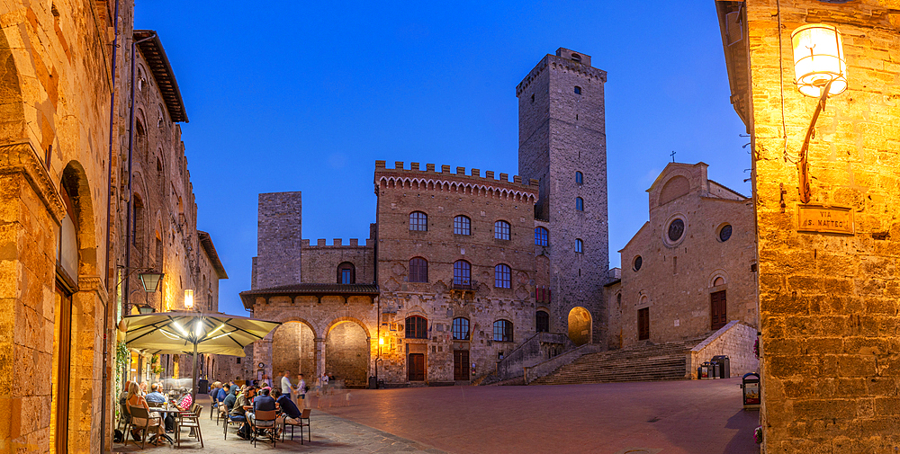 View of restaurants in Piazza del Duomo at dusk, San Gimignano, UNESCO World Heritage Site, Province of Siena, Tuscany, Italy, Europe