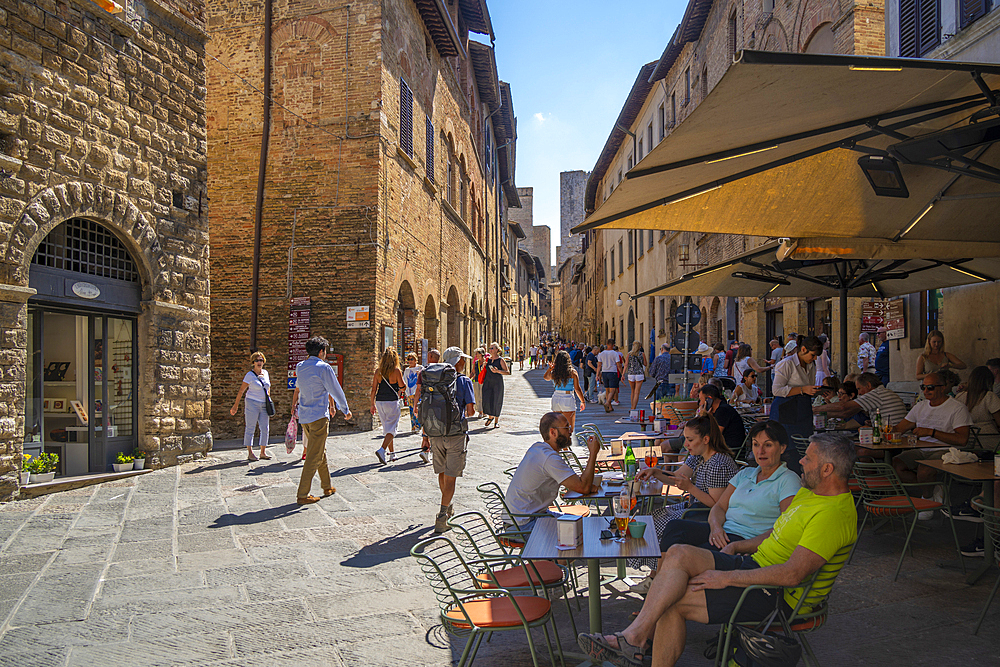 View of cafe and bar in narrow street in San Gimignano, San Gimignano, Province of Siena, Tuscany, Italy, Europe