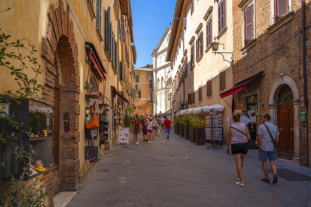 View of shops and shoppers in narrow street in Montepulciano, Montepulciano, Province of Siena, Tuscany, Italy, Europe