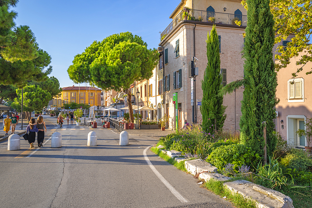 View of colourful buildings, cafe and cypress trees in Borgo San Giuliano, Rimini, Emilia-Romagna, Italy, Europe