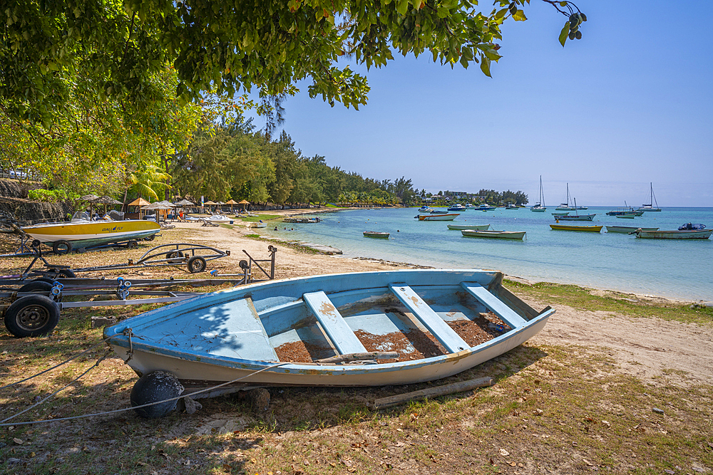 View of boat on beach and turquoise Indian Ocean on sunny day in Cap Malheureux, Mauritius, Indian Ocean, Africa