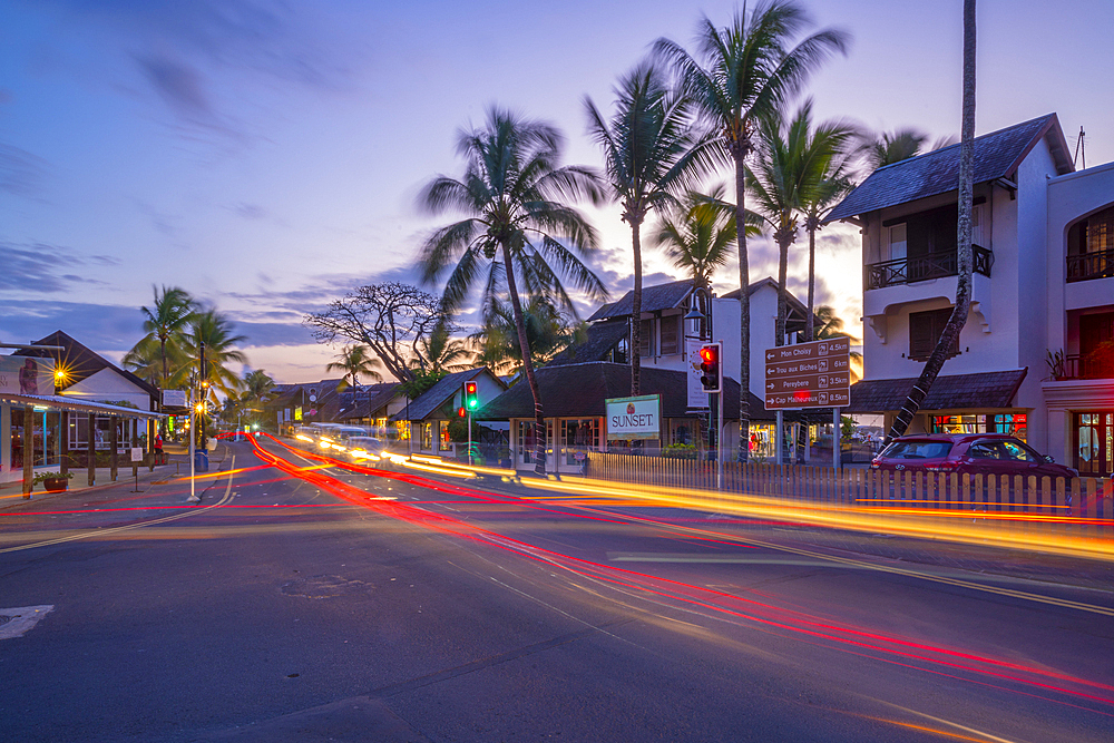 View of palm trees and boutique shops in Grand Bay at dusk, Mauritius, Indian Ocean, Africa