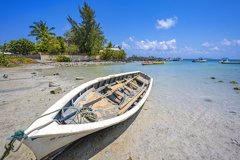 View of boat on beach and turquoise Indian Ocean on sunny day near Poste Lafayette, Mauritius, Indian Ocean, Africa