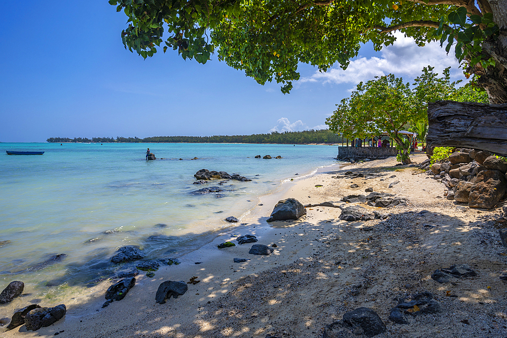 View of man fishing from Mont Choisy Beach and turquoise Indian Ocean on sunny day, Mauritius, Indian Ocean, Africa