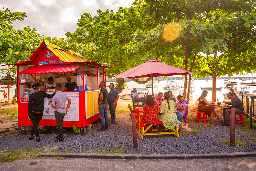 View of food stall in Grand Baie and boats in background, Grand Bay, Mauritius, Indian Ocean, Africa