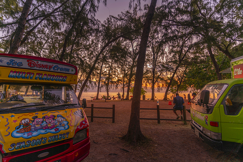 View of people on Mon Choisy Public Beach at sunset, Mauritius, Indian Ocean, Africa