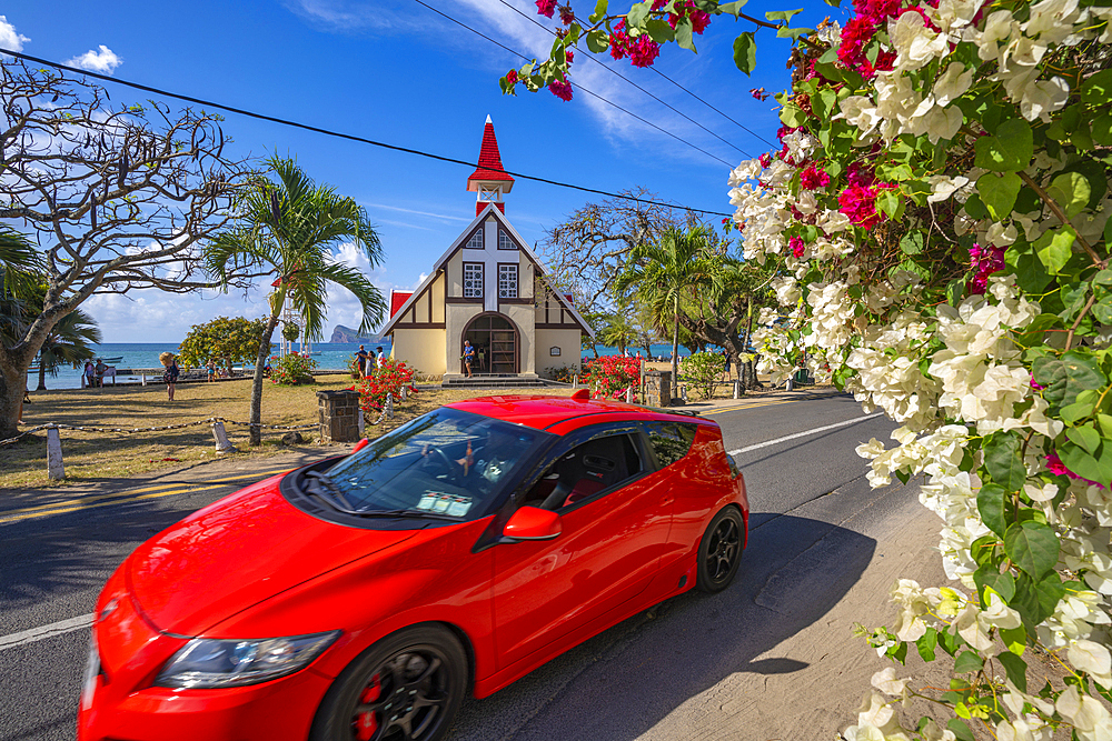 View of red car and Notre-Dame Auxiliatrice de Cap Malheureux, Cap Malheureux, Mauritius, Indian Ocean, Africa