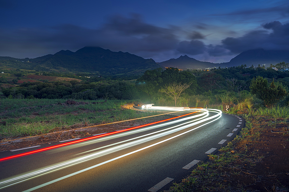 View of trail lights and Long Mountains at dusk near Nouvelle Decouverte, Mauritius, Indian Ocean, Africa