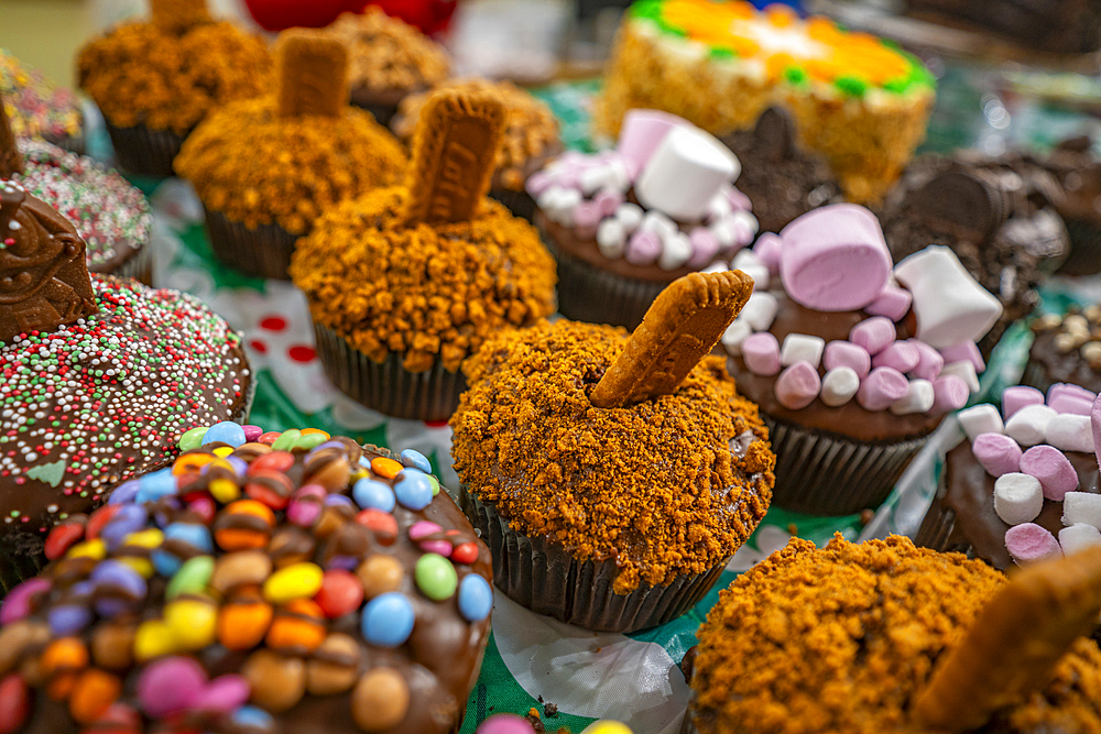 Cakes on Christmas Market stall in Old Market Square at dusk, Nottingham, Nottinghamshire, England, United Kingdom, Europe