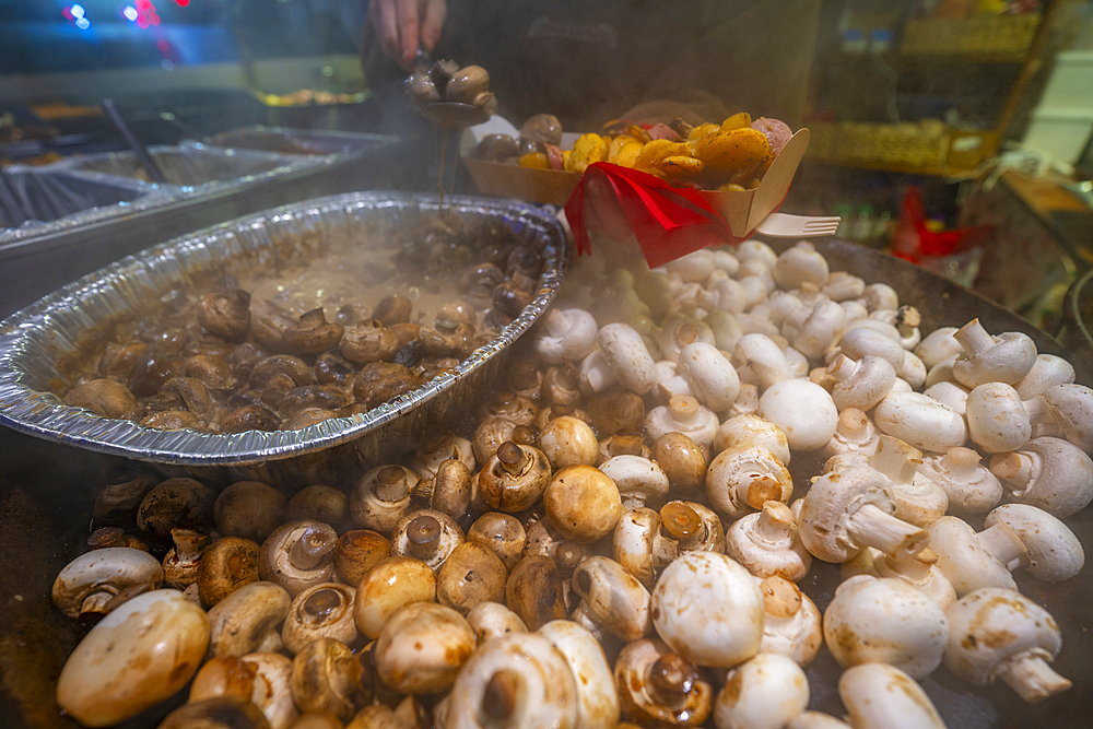 Hot mushrooms on Christmas Market stall in Old Market Square at dusk, Nottingham, Nottinghamshire, England, United Kingdom, Europe