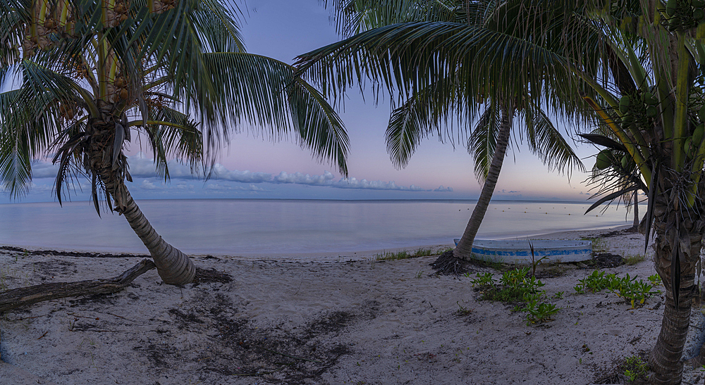 View of rustic canoe boat on beach at sunset near Puerto Morelos, Quintana Roo, Caribbean Coast, Yucatan Peninsula, Riviera Maya, Mexico, North America