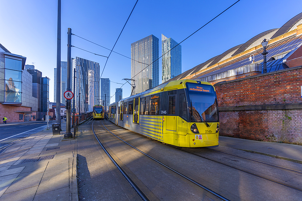 View of apartment buildings, city tram and Tower Of Light, Manchester, Lancashire, England, United Kingdom, Europe