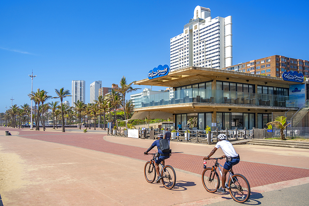 View of cyclists, cafe and hotels on promenade, Durban, KwaZulu-Natal Province, South Africa, Africa