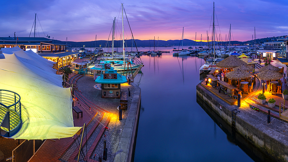 View of boats and restaurants at Knysna Waterfront at dusk, Knysna, Western Cape Province, South Africa, Africa