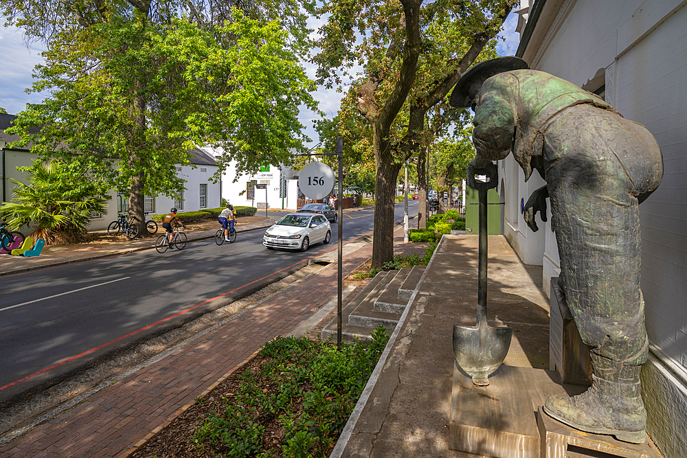 View of Old Mac statue and cyclists in street, Stellenbosch Central, Stellenbosch, Western Cape, South Africa, Africa