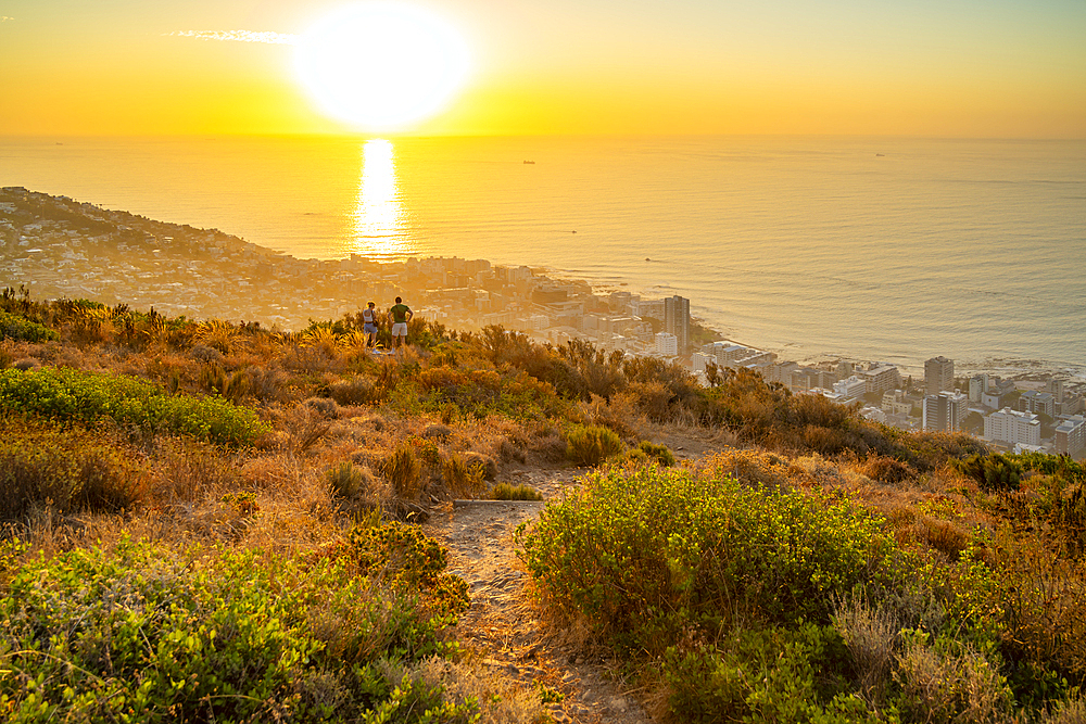 Couple watching sunset over Bantry Bay from Signal Hill, Cape Town, Western Cape, South Africa, Africa