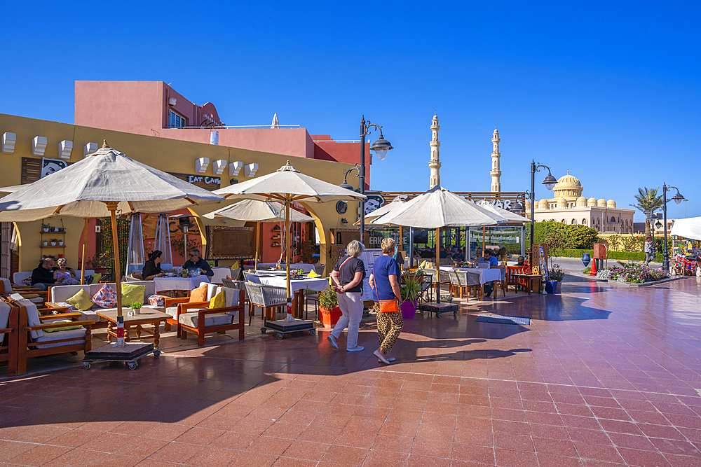 View of cafe and restaurant in Hurghada Marina and Al Mina Mosque in background, Hurghada, Red Sea Governorate, Egypt, North Africa, Africa