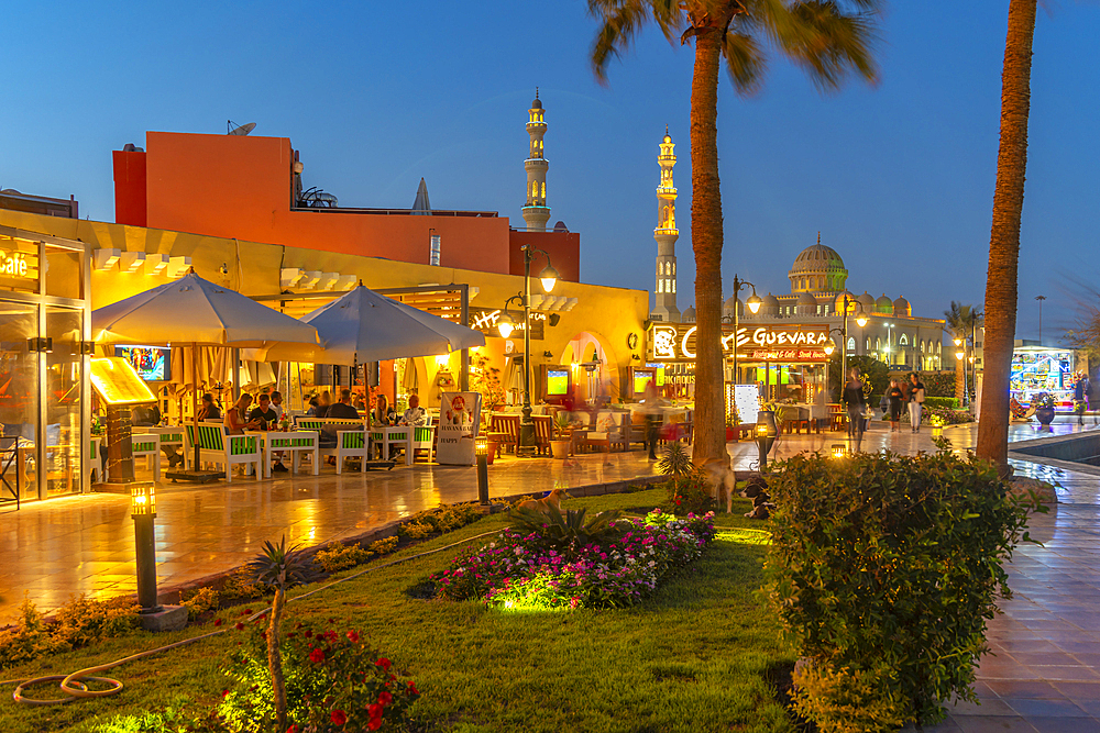 View of cafe and restaurant in Hurghada Marina and Al Mina Mosque in background at dusk, Hurghada, Red Sea Governorate, Egypt, North Africa, Africa