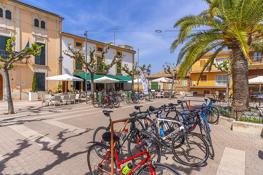 View of cycles in Placa Mayor in hilltop town of Campanet, Majorca, Balearic Islands, Spain, Mediterranean, Europe