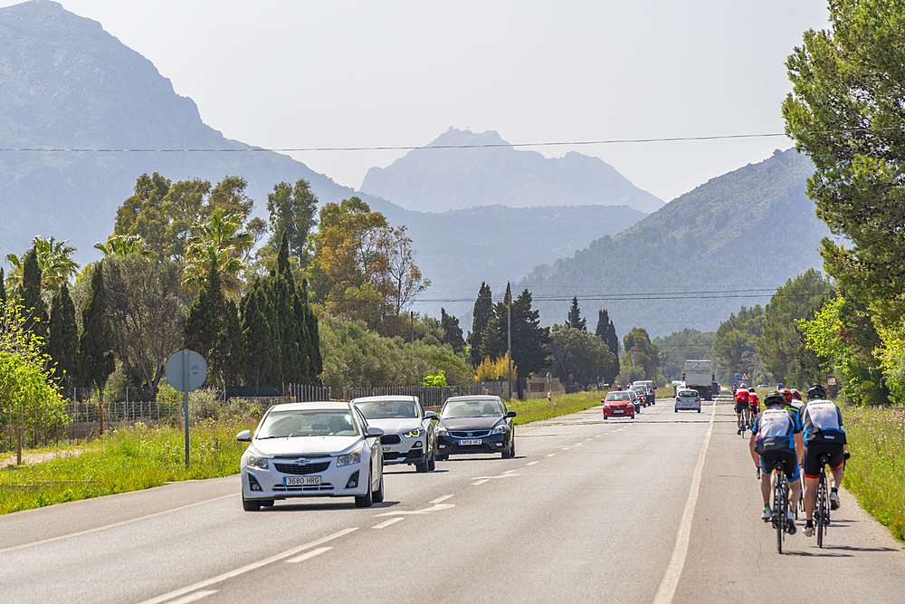 View of cyclists and cars on the road and hills at Polllenca, Majorca, Balearic Islands, Spain, Mediterranean, Europe