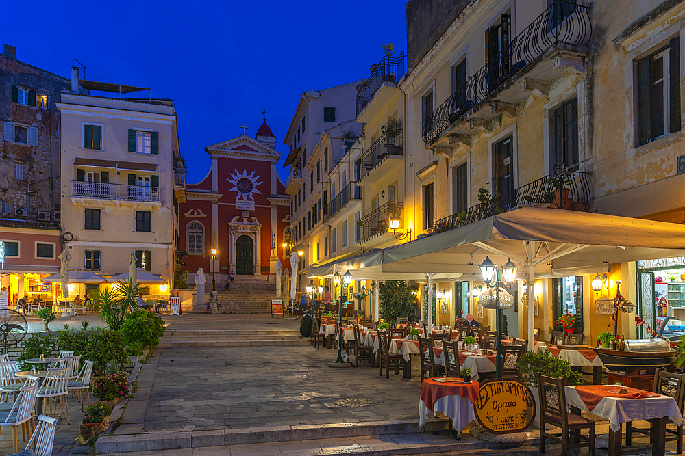 View of restaurants in Mitropolis Square, old Corfu Town at dusk, UNESCO World Heritage Site, Corfu, Ionian Sea, Greek Islands, Greece, Europe