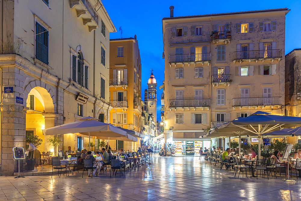 View of buildings and restaurants on Kofineta Square at dusk, Corfu Old Town, UNESCO World Heritage Site, Corfu, The Ionian Islands, Greek Islands, Greece, Europe