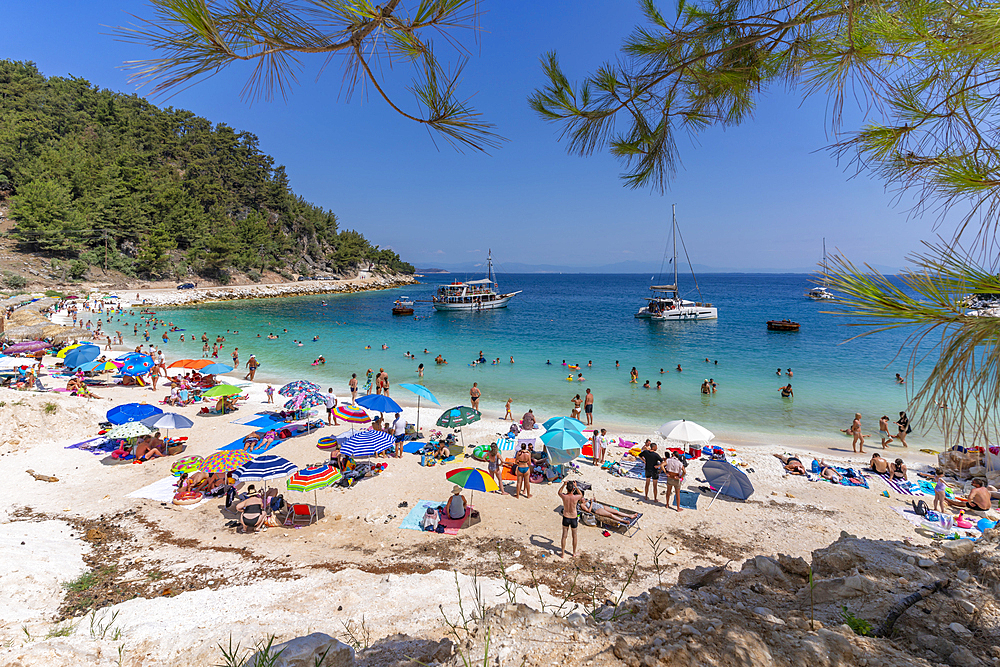 View of beach scene and boat on the sea at Porto Vathy, Makriammos, Thassos, Aegean Sea, Greek Islands, Greece, Europe