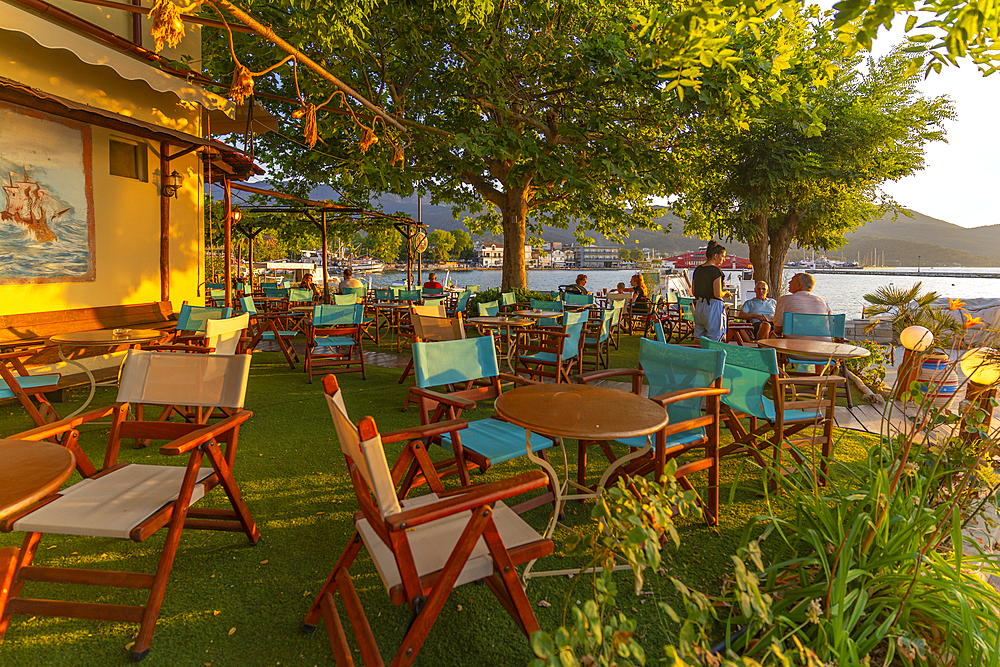 View of restaurant in old harbour in Thassos Town during golden hour, Thassos, Aegean Sea, Greek Islands, Greece, Europe