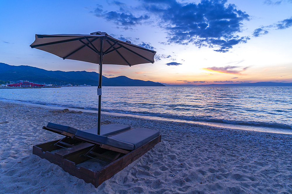 View of sun lounger on the beach and Aegean Sea after sunset, Thassos Town, Thassos, Aegean Sea, Greek Islands, Greece, Europe