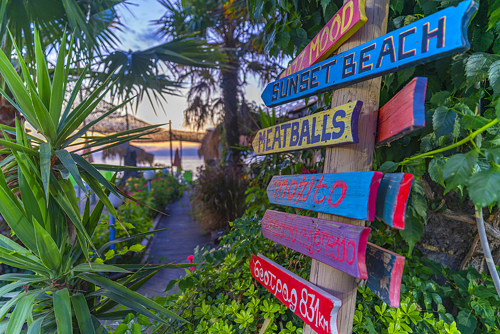 View of signpost on beach after sunset, Thassos Town, Thassos, Aegean Sea, Greek Islands, Greece, Europe