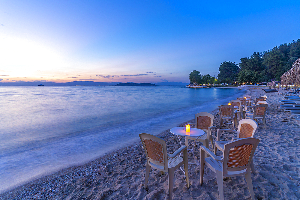 View of restaurant tables on beach after sunset, Thassos Town, Thassos, Aegean Sea, Greek Islands, Greece, Europe