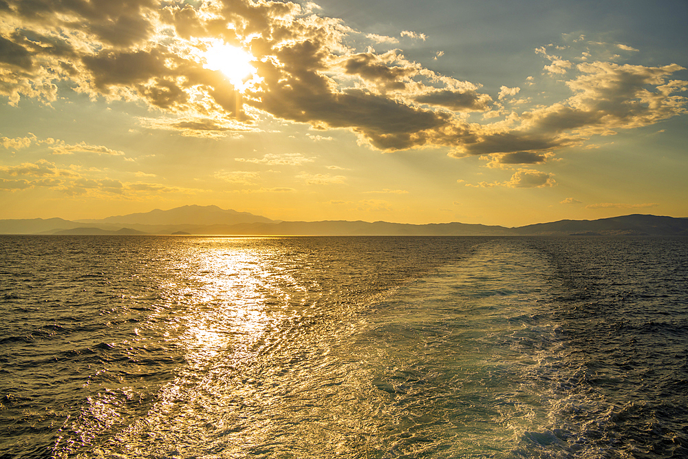 View of Greek mainland from ferry at sunset, Kavala, Dimos Kavalas, Eastern Macedonia and Thrace, Gulf of Thasos, Gulf of Kavala, Greece, Europe