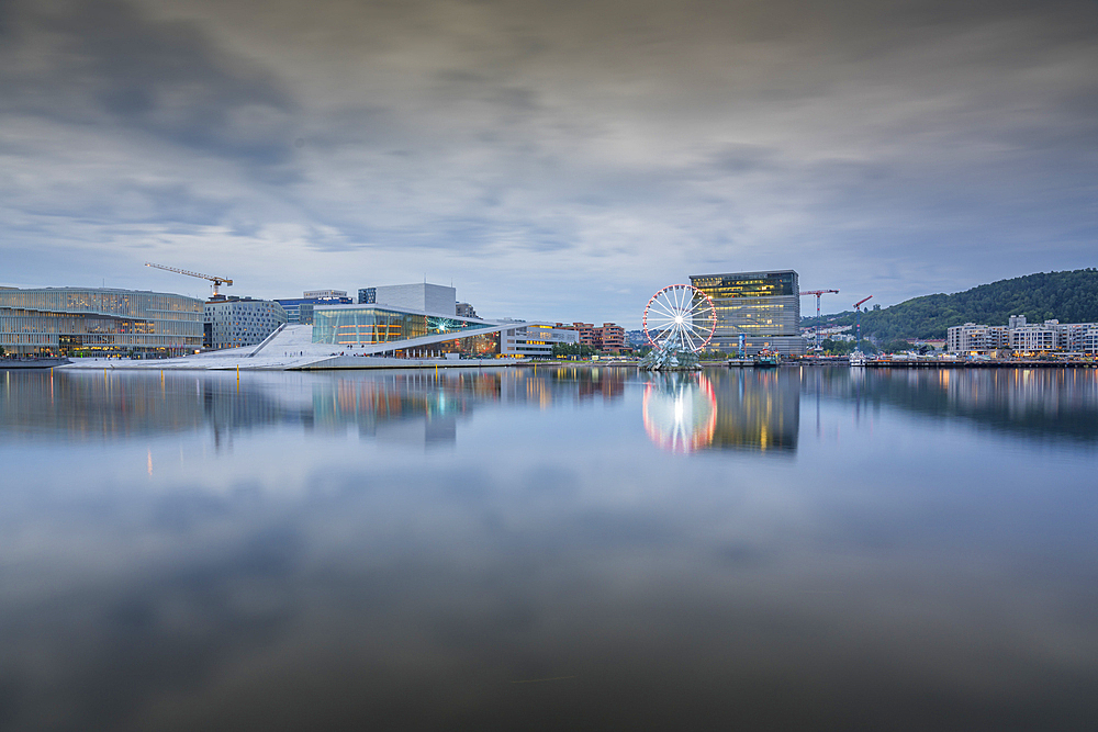 View of Oslo Opera House and Munch Museum reflecting in harbour on cloudy day, Oslo, Norway, Scandinavia, Europe