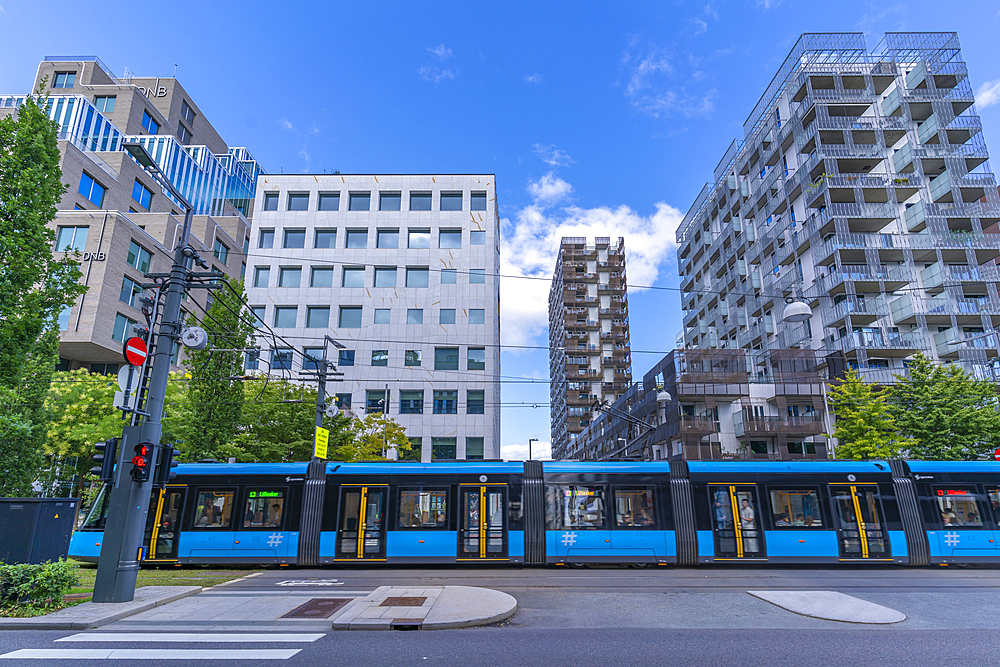 View of city tram and contemporary architecture in the Barcode area on a sunny day, Oslo, Norway, Scandinavia, Europe