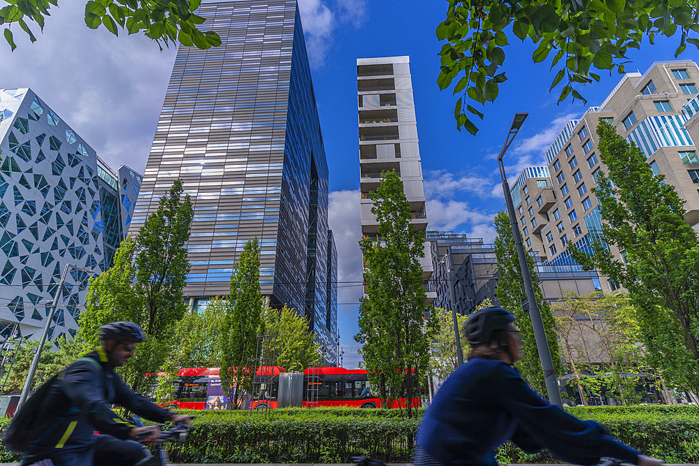 View of cyclists and contemporary architecture in the Barcode area on a sunny day, Oslo, Norway, Scandinavia, Europe