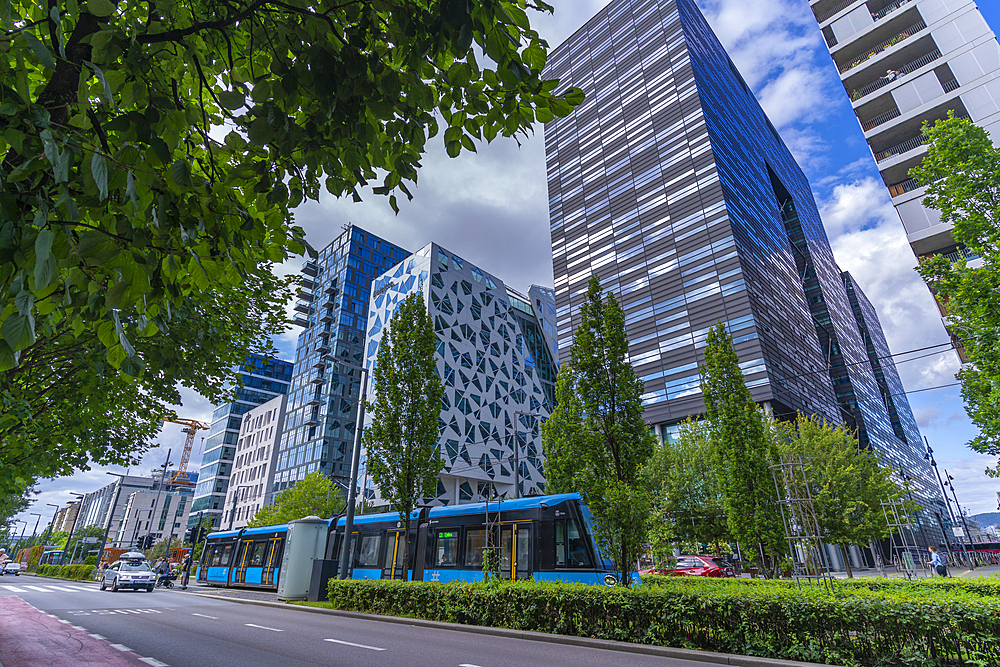 View of city tram and contemporary architecture in the Barcode area on a sunny day, Oslo, Norway, Scandinavia, Europe