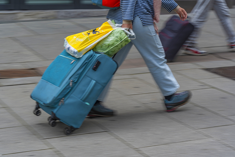 View of people with roller suitcases heading for Central Station, Oslo, Norway, Scandinavia, Europe