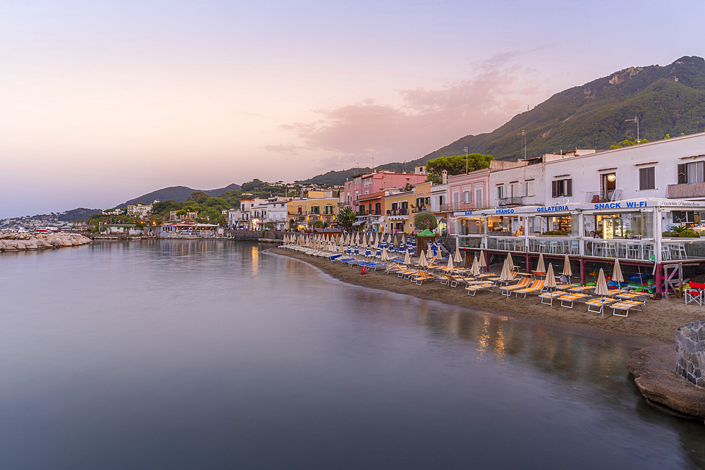 View of beach and the town of Lacco Ameno at sunset, Island of Ischia, Campania, Italy, Europe