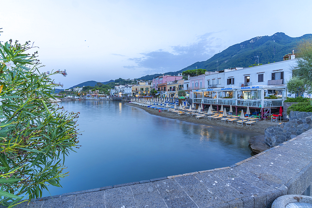 View of beach and the town of Lacco Ameno at sunset, Island of Ischia, Campania, Italy, Europe