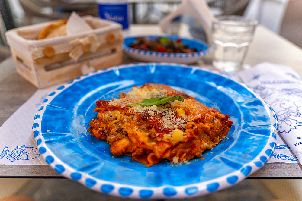 View of Italian lasagne on restaurant table, Island of Ischia, Campania, Italy, Europe