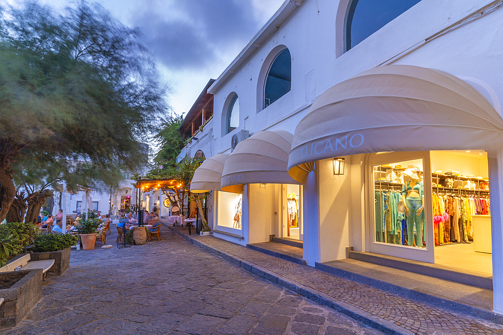 View of shops in Porto di Sant'Angelo at dusk, Sant'Angelo, Island of Ischia, Campania, Italy, Europe