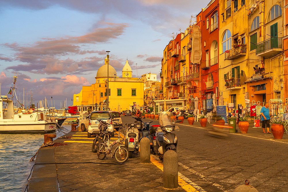 View of Church Madonna delle Grazie in the fishing port Marina Grande with shops at golden hour, Procida, Phlegraean Islands, Gulf of Naples, Campania, Southern Italy, Italy, Europe