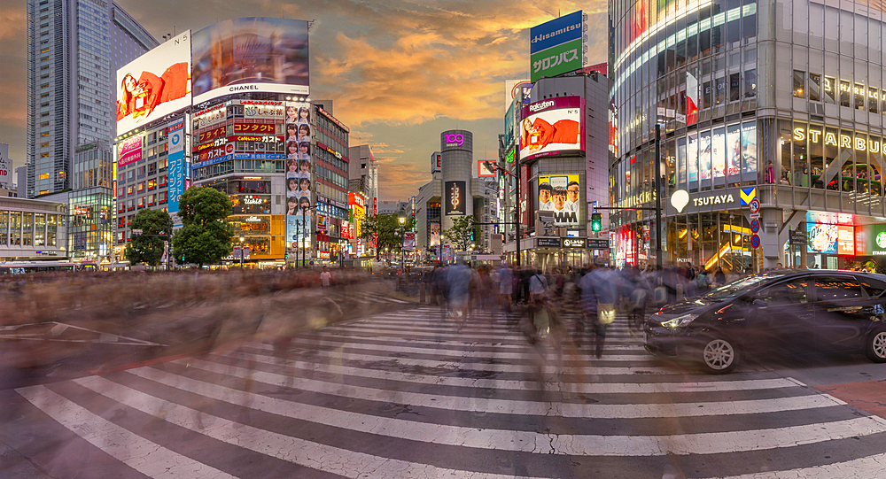 View of people at the world's busiest road crossing, Shibuya Scramble Crossing at sunset, Minato City, Tokyo, Japan, Asia