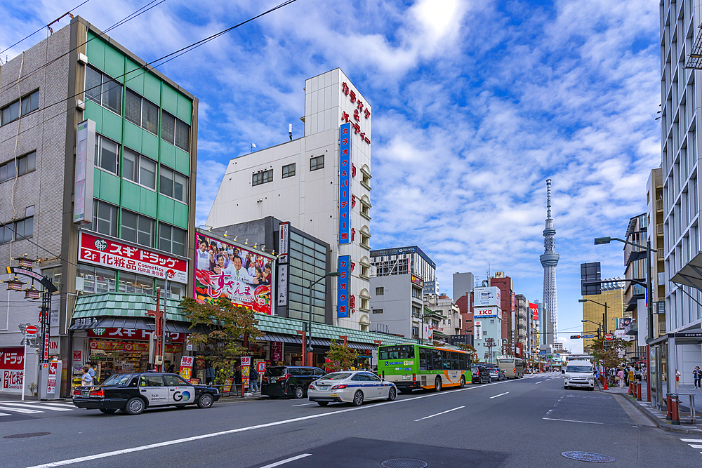 View of colourful shops and buildings with Tokyo Skytree visible in background, Asakusa, Taito City, Tokyo, Japan, Asia