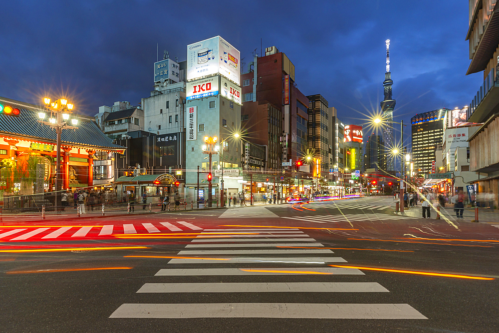 View of colourful shops and buildings with Tokyo Skytree visible in background at night, Asakusa, Taito City, Tokyo, Japan, Asia