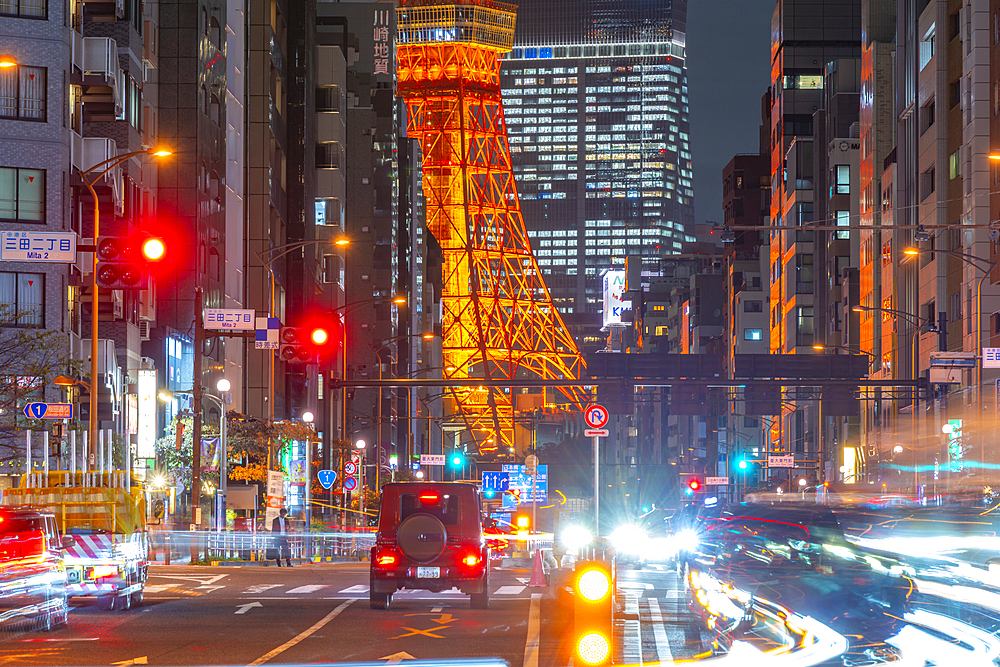 View of Tokyo Tower, city street and trail lights at night, Minato City, Tokyo, Honshu, Japan