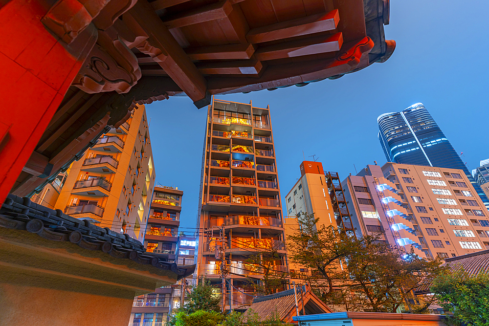 View of Tokyo Tower reflecting in city buildings and Rurikoji Buddhist Temple at night, Minato City, Tokyo, Honshu, Japan