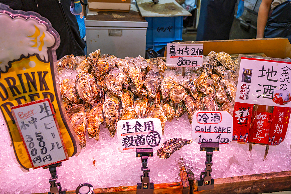 View of cold Sake on fish stall in Omicho Market, Kanazawa City, Ishikawa Prefecture, Honshu, Japan