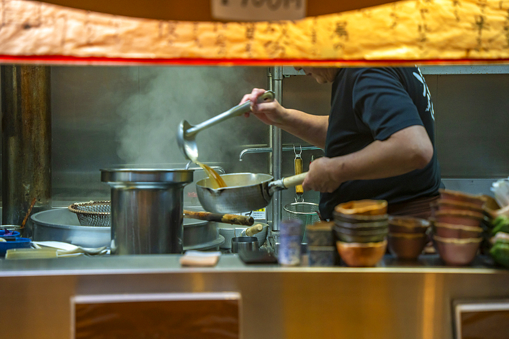 View of chefs busy at work through restaurant window in Omicho Market, Kanazawa City, Ishikawa Prefecture, Honshu, Japan